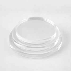 Stack of three clear cast acrylic disc circles in different sizes.