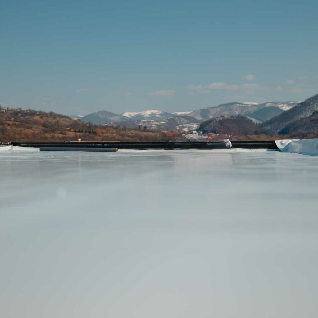 A PVC roof with a mountainous background.