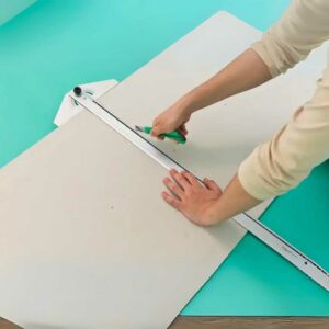 Someone cutting a PVC sheet.