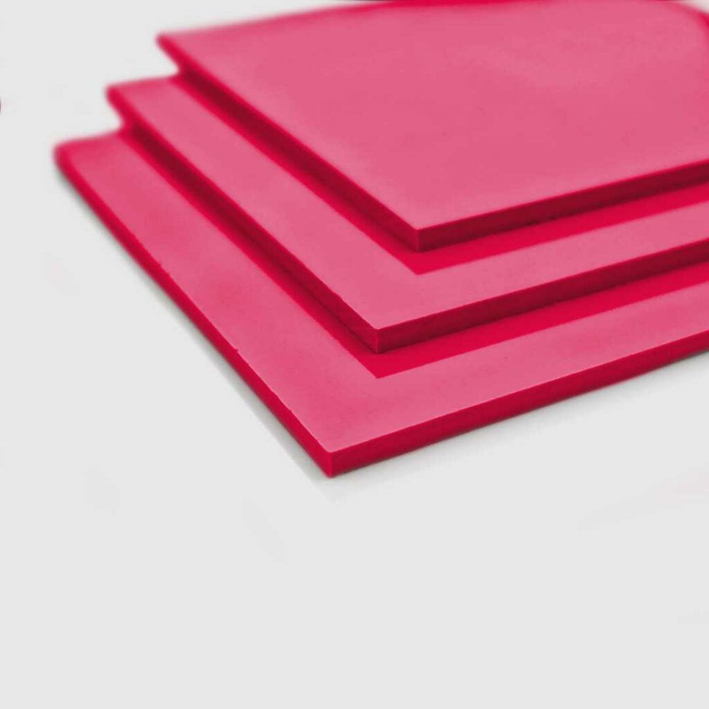 Stacked sheets of pink pvc.