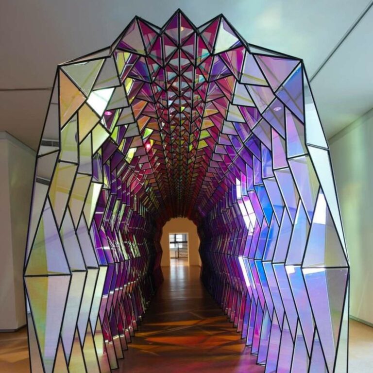A colourful tunnel made from mirrored sheets.