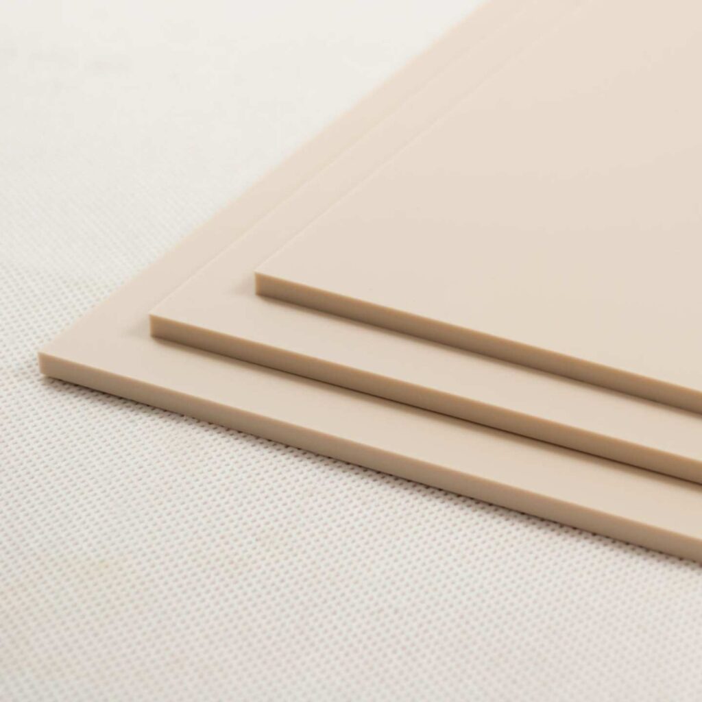 Stacked sheets of natural desert beige coloured perspex acrylic.