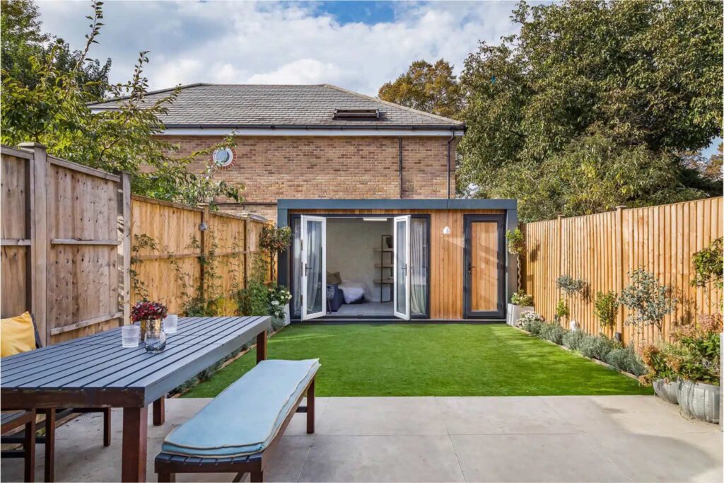 A summer house at the end of a garden.