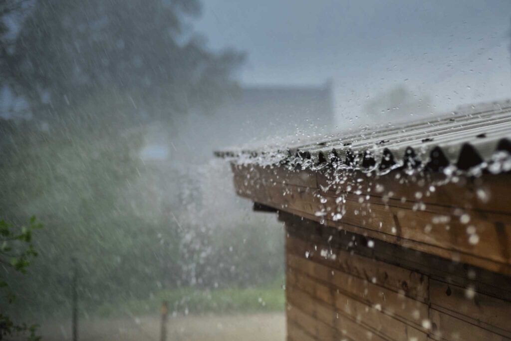 Water droplets running off a shed roof.