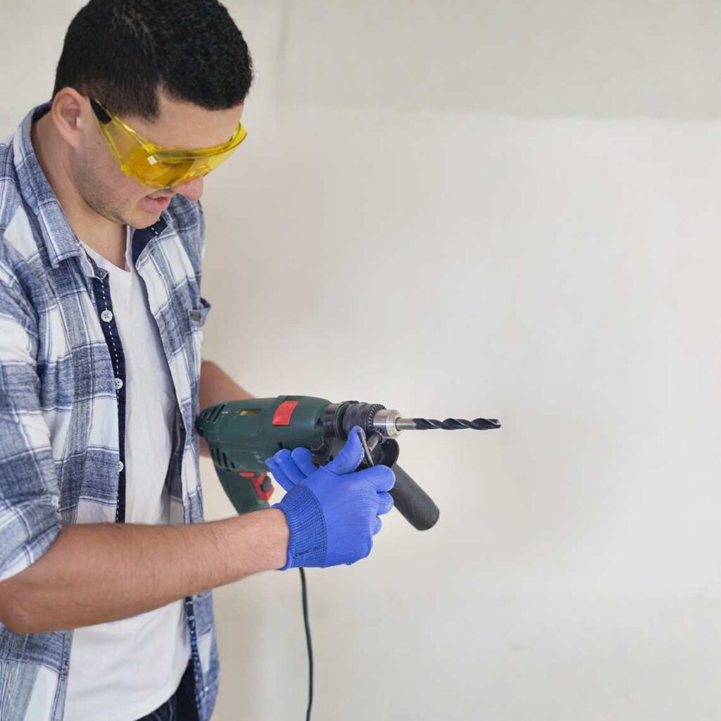 A man holding a drill.